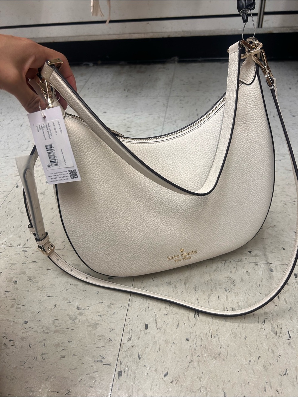 kate spade cream pebbled leather crescent shoulder bag with gold hardware